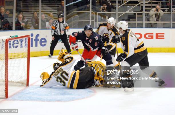 New York Rangers' Jaromir Jagr rushes to the Boston Bruins' net as a one-man team in an attempt to score on Bruins' goalie Tim Thomas while boxed in...