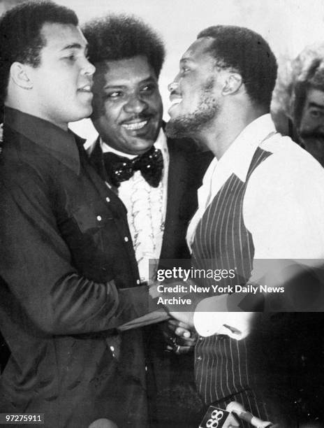 Muhammad Ali and Joe Frazier shake hands as Don King looks on at press conference in the Rainbow Room.