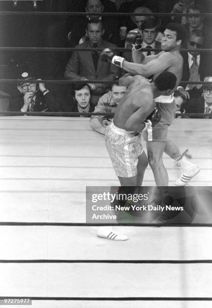 Muhammad Ali misses left hook in first round and Joe Frazier steps under to counter with his left to body.