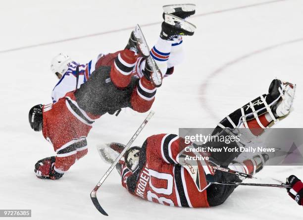 New York Rangers' Sean Avery and New Jersey Devils' Paul Martin collide with Devils' goaltender Martin Brodeur in the 3rd period of Game 5 of the NHL...