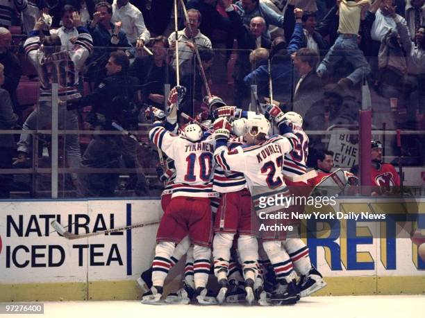 New York Rangers' Stephane Matteau is mobbed by teammates after his goal at 4:24 of the second overtime period gives the Rangers' a 2-1 win over the...