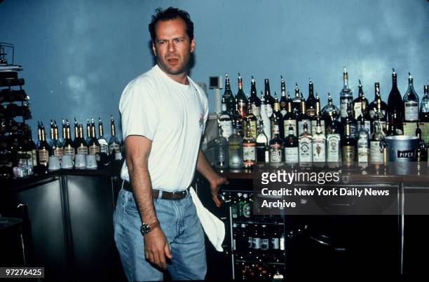 Co-owner Bruce Willis tends bar at Planet Hollywood