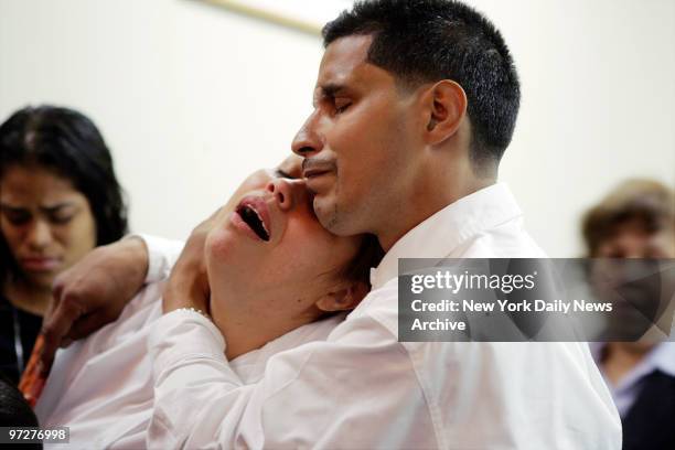 Coralys Cruz and Jose Santiago weep during a wake for their daughter, Jocelys Santiago, at the Rivera Funeral Home on Bathgate Ave. In the Bronx....