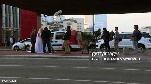 Husband and wife Ademir Avelino and Glaucia Sudan pose in wedding clothes for pictures in Sao Paulo on June 8, 2018. - The Brazilian couple have the...