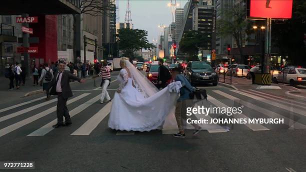 Husband and wife Ademir Avelino and Glaucia Sudan pose in wedding clothes for pictures in Sao Paulo on June 8, 2018. - The Brazilian couple have the...