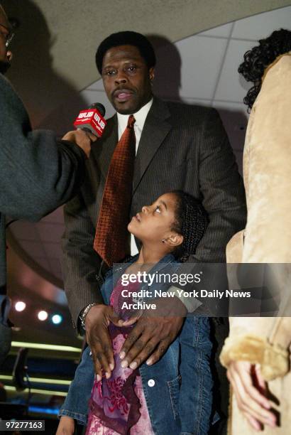 Corey Ewing looks on as her dad, former New York Knick Patrick Ewing, speaks to media during a news conference at the Theater in Madison Square...