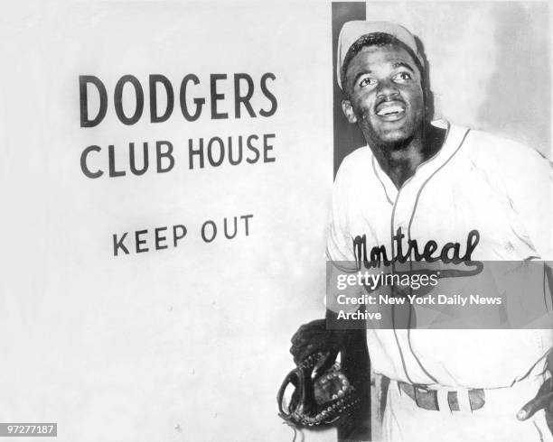 Jackie Robinson, the first black to be admitted to the major leagues, enters the Brooklyn Dodgers' clubhouse after the Dodgers announced they had...