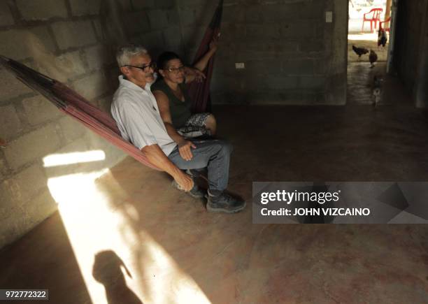 Jose Alarcon, sits with his wife on a hammock at their farm in Cedro Cocido, near Leticia in rural Monteria, Cordoba Department, northern Colombia,...