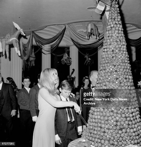 Brigitte Bardot and Jonathan Eden who appears with Bardot in " ??Viva Mar?fa!," cut a friend's Christmas cake at a Bardot party at the Beverly Hills...