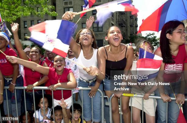 Flags and cheers greet the marchers at the 14th annual Bronx Dominican Day Parade down the Grand Concourse.