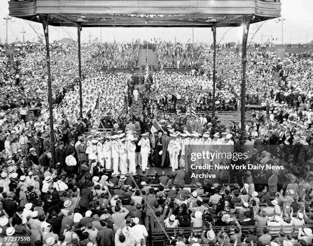 Flanked by his white-clad officers, Gen. Italo Balbo speaks into mike that carries his voice every part of the vast Madison Square Garden Bowl at...