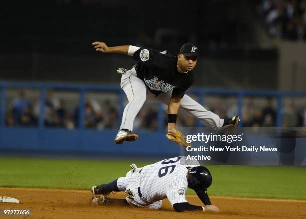 Florida Marlins' Alex Gonzalez gets New York Yankees' Nick Johnson out at second base, but accidentally kicks him in the head during a double play in...