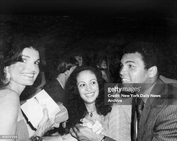 Jacqueline Kennedy Onassis greets world heavyweight boxing champion Muhammad Ali and his wife, Veronica, as festivities get under way at Rainbow Room.