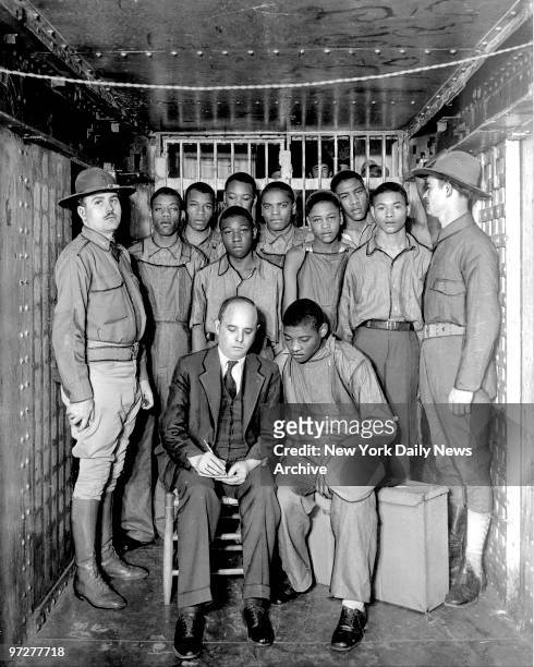 Scottsboro Case - Attorney Sam Leibowitz confers with Haywood Patterson in a County Jail cell. Six of his co-defendants stand behind him. Trials of...