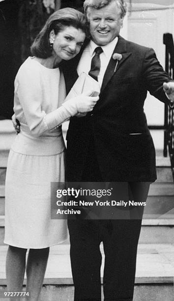 Jacqueline Kennedy Onassis leans on the shoulder of her brother-in-law, Sen. Edward Kennedy, at the wedding of her daughter, Caroline Kennedy.