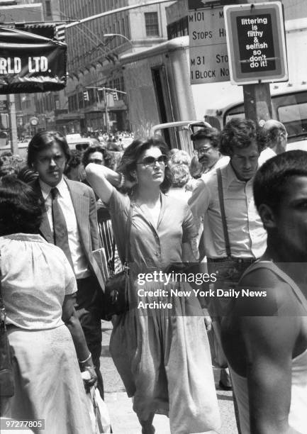 Jacqueline Kennedy Onassis walks with two companions down Lexington Ave., south towards 57th St.,