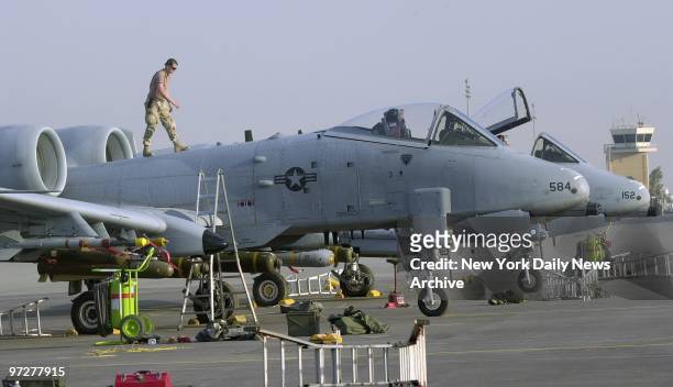 Flight crews get A-10 Thunderbolt jets ready for flights over Iraq at a 75th Fighter Squadron base near the Iraqi border.