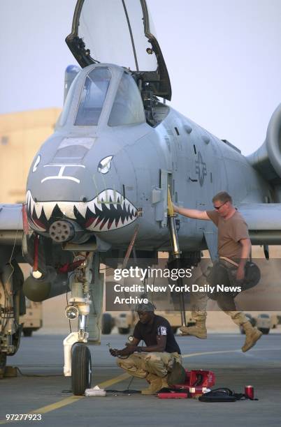 Flight crews get an A-10 Thunderbolt jet ready for a flight over Iraq at a 75th Fighter Squadron base near the Iraqi border.