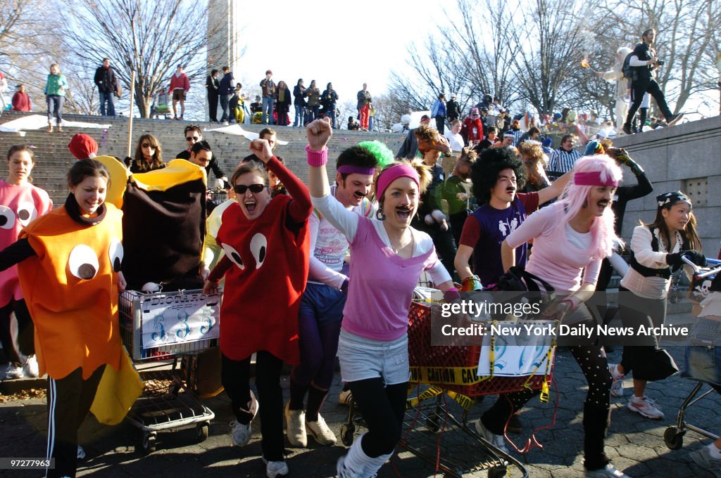 Costumed crew members push and drag their shopping carts dow