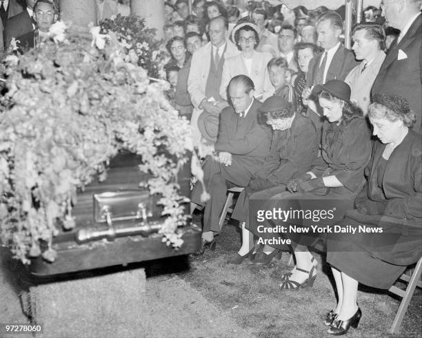 The grieving family sits by the casket as last rites are pronounced in the Gate of Heaven cemetery in Hawthorne, N.Y. Daughter and son-in-law Mr. And...