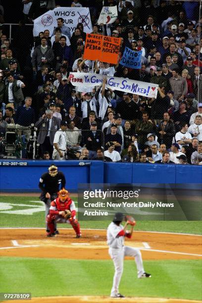 New York Yankee fans wave signs, including those reading "Who's Your Daddy" and "Pedro, Ya Gonna Get Spanked!," as Boston Red Sox pitcher Pedro...