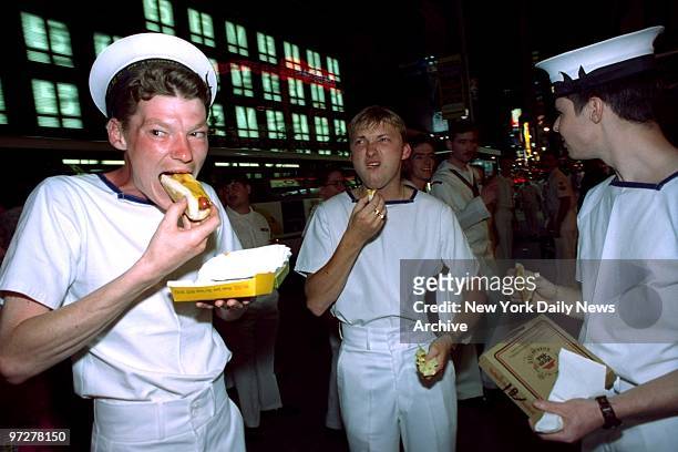 British sailors, here for Fleet Week, seem to have mixed feelings about American hot dogs at Nathan's in Times Square.,