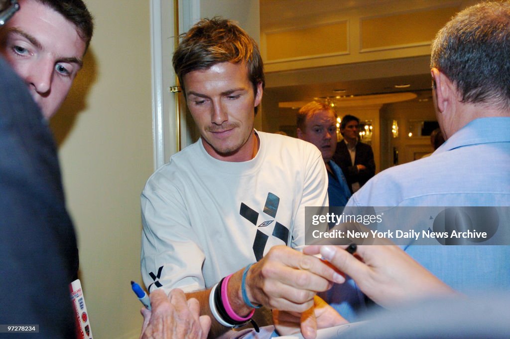 British soccer star David Beckham signs autographs for fans
