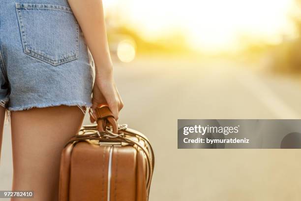 young woman going on road - the runaways stock pictures, royalty-free photos & images