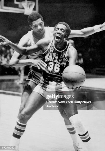 The Harlem Globetrotters' Meadowlark Lemon and New Jersey Reds' General Holman during a game at Madison Square Garden.