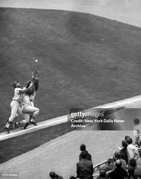 Cepeda, Maris and Javier collide chasing foul ball. , 1. Cepeda, Javier and Maris eye high-lofting ball as they close on each other.,