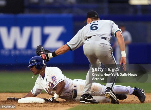 Florida Marlins' Andy Fox tags New York Mets' Melvin Mora as he was caught stealing second in the first inning at Shea Stadium. The Mets went on to...