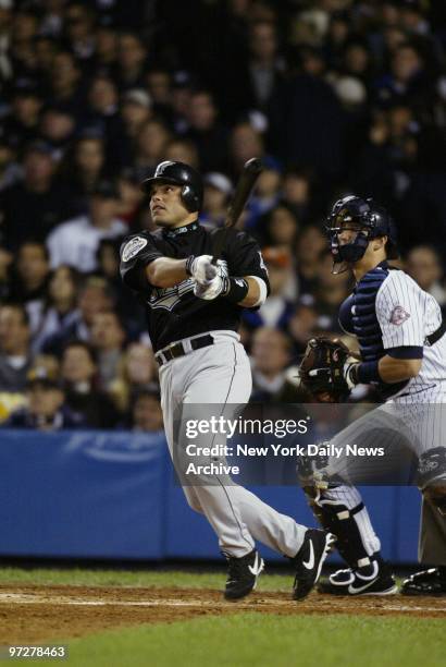 Florida Marlins' catcher Ivan Rodriguez hits a sacrifice fly to score outfielder Juan Pierre in the first inning of Game 1 of the World Series...
