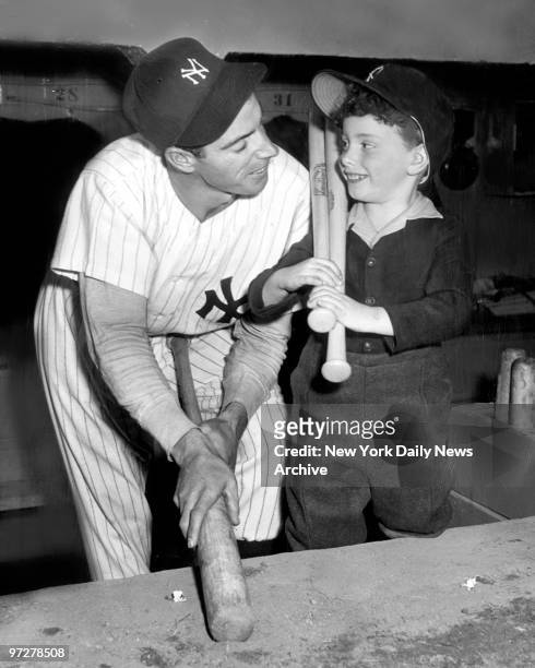 Yankees slugger Joe DiMaggio and son Joe DiMaggio Jr. In dugout at Yankee Stadium.