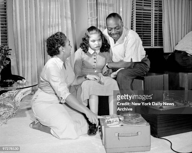 Count Basie and wife Catherine with daugher Diane listeniing to tape recording of newest Basie rendition.