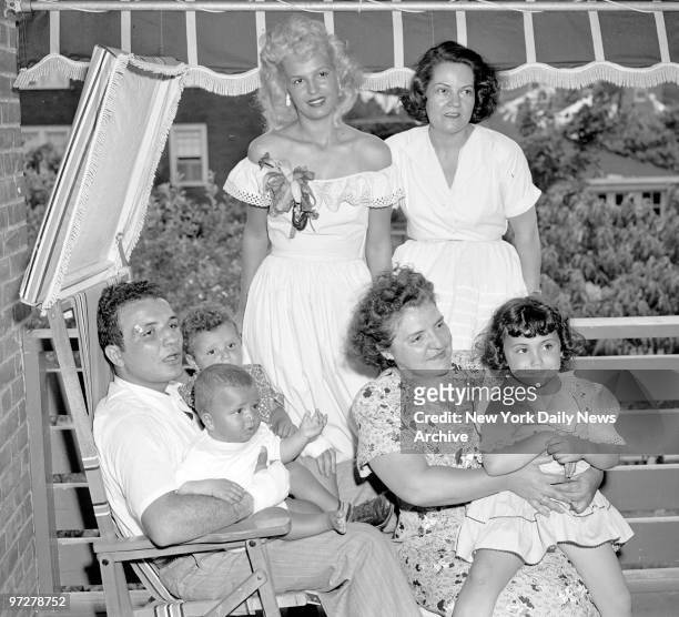 Jake LaMotta holds 2-year-old Jackie and Joe, 8 months, as his mother holds daughter Jacqueline, 4. Jake's blonde wife, Vickie, and her mother, Mrs....