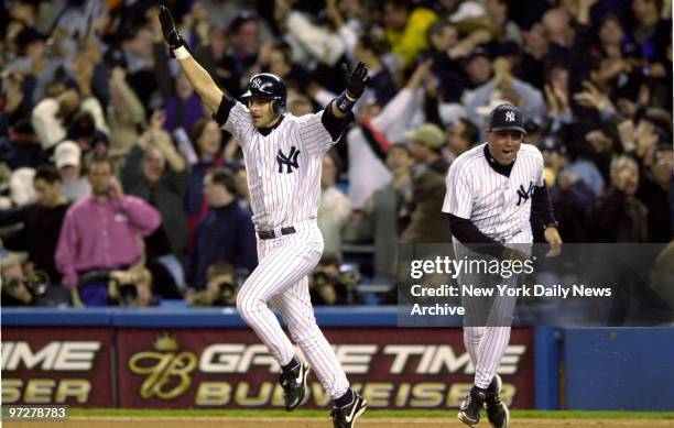 New York Yankees' Aaron Boone celebrates as he runs the bases after hitting the game winning home run in the 11th inning of Game 7 of the American...