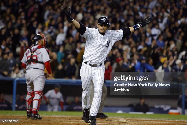 New York Yankees' Aaron Boone celebrates as he runs the bases after hitting the game winning home run in the 11th inning of Game 7 of the American...