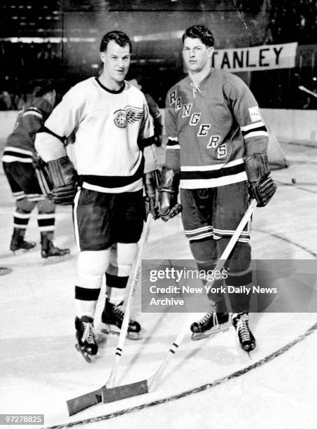 The Howe brothers face each other on the ice. On left is Gordie Howe of the Detroit Red Wings and on right is Vic Howe of the New York Rangers circa...