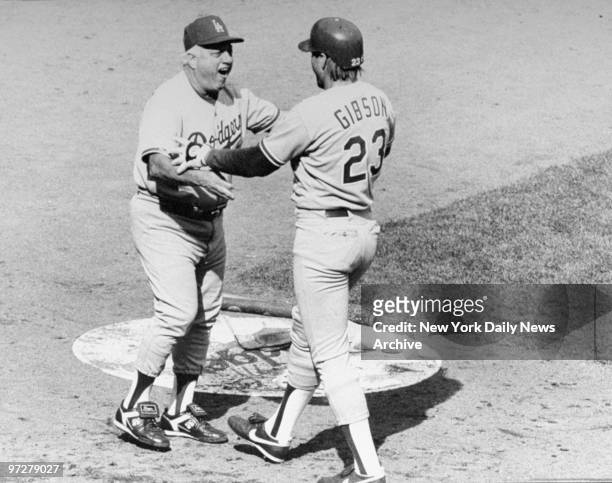 Los Angeles Dodgers' manager Tommy Lasorda greets Kirk Gibson after he hit a homer against the New York Mets.