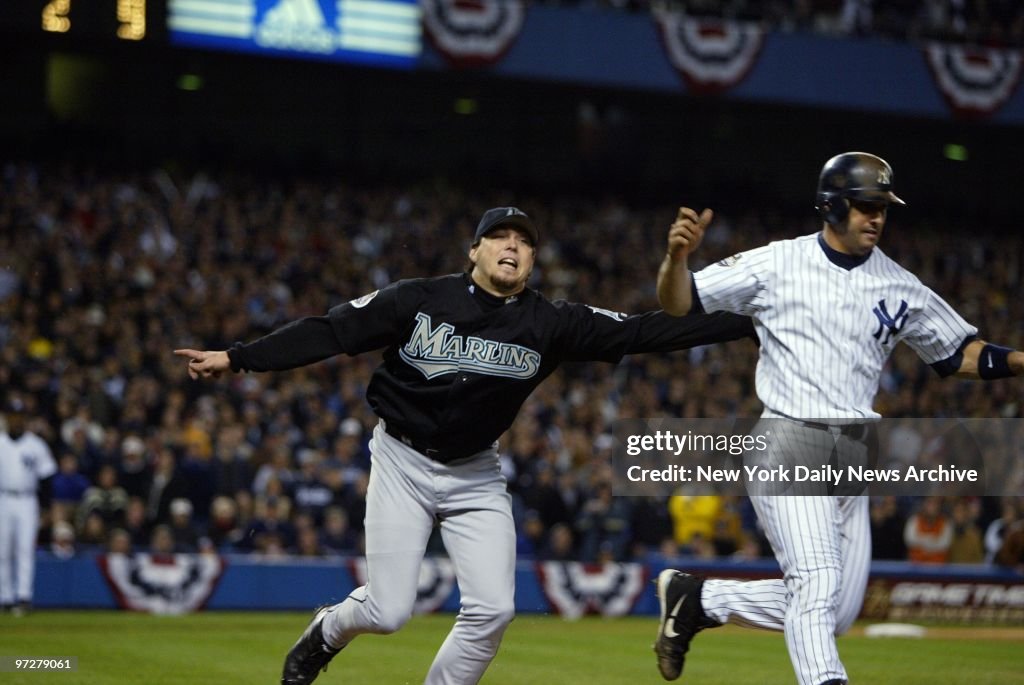 Florida Marlins' Josh Beckett tags New York Yankees' catcher