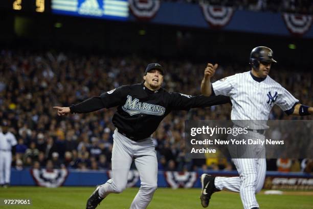 Florida Marlins' Josh Beckett tags New York Yankees' catcher Jorge Posada for the final out of the game after Posada grounded up the first baseline...