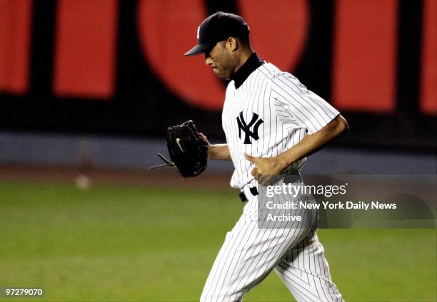 New York Yankees' closer Mariano Rivera jogs to the mound after being called on to work out of a jam in the eighth inning of Game 1 of the American...