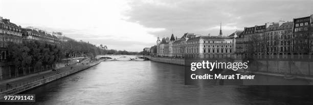 panorama along the seine river with the french supreme court and the conciergerie - pont au change stock pictures, royalty-free photos & images