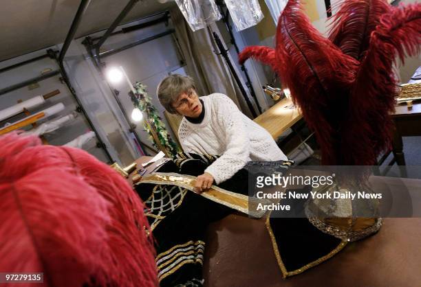 Seamstress Sally Dedrick puts the finishing touches on a Mardi Gras ball costume in the first-floor sewing room at her home in the Kenner section of...