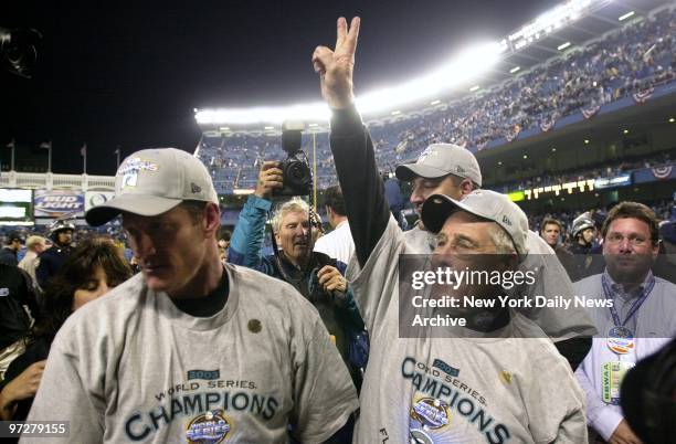 Florida Marlins' manager Jack McKeon raises his hand in victory at Yankee Stadium after the Marlins shut out the New York Yankees, 2-0, in Game 6 to...