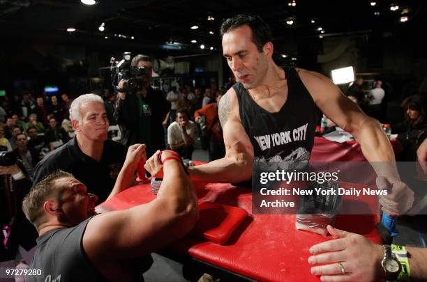 Frank Hirst of Griswald, Conn. , forces the arm of a grimacing Kevin Nelson of Holbrook, N.Y., to the table to win a matchup in the 225-lb. Weight...