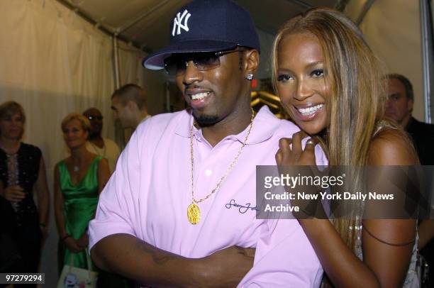 Sean Combs gets a hug from supermodel Naomi Campbell backstage during the Fashion for Relief runway show at the tents in Bryant Park on the last day...