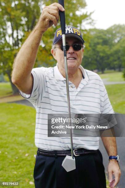 Former Mayor Rudolph Giuliani shows off his pentagonal putter while at the Trump National Golf Course in Westchester, where he co-hosted a golf...