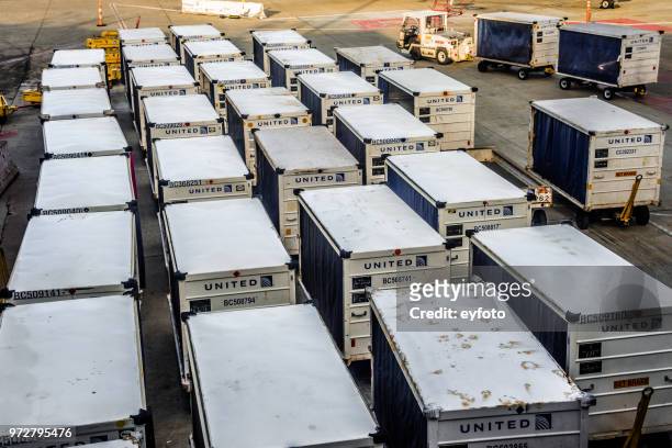 cargo carts at airport - respiratory failure stock pictures, royalty-free photos & images