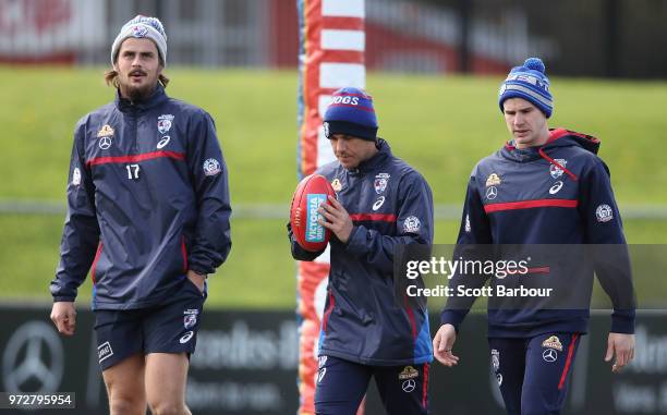 Tom Boyd of the Bulldogs and Billy Gowers of the Bulldogs walk during a Western Bulldogs AFL training session at Whitten Oval on June 13, 2018 in...